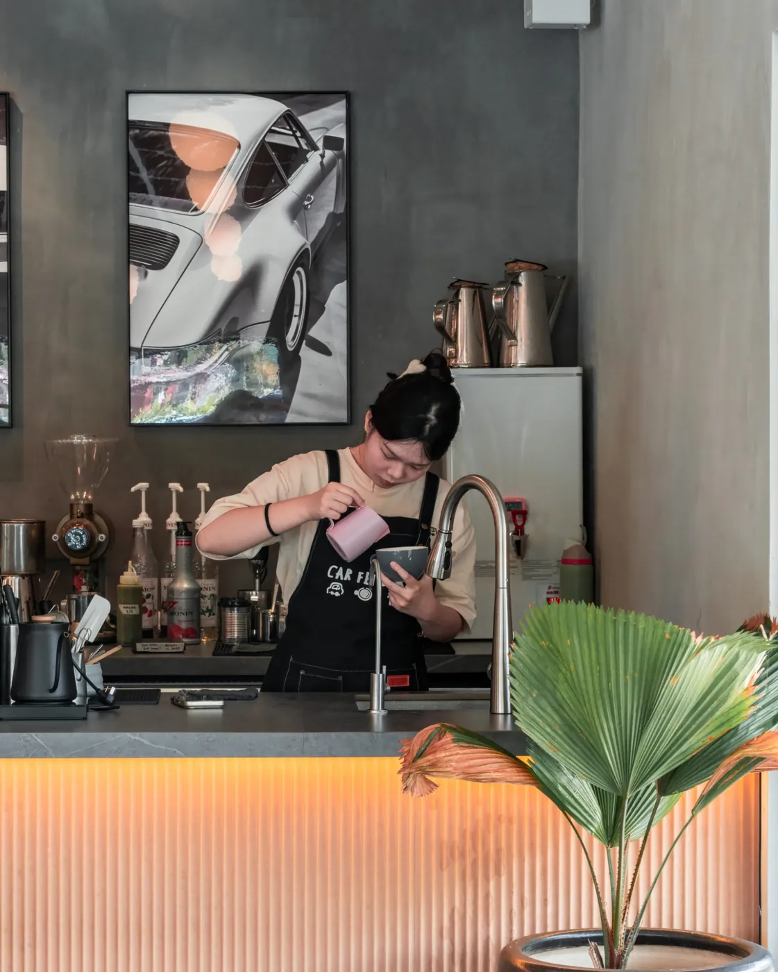 Barista pouring at the espresso bar